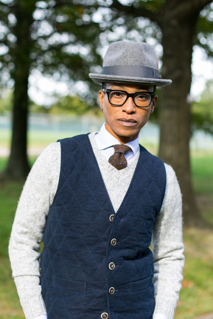Photo of a Black gentleman dressed in dapper clothes and hat