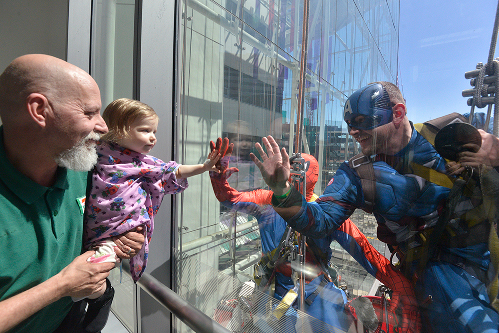 Window Washers Bring Joy At Children's Hospital dressing up like Superheros